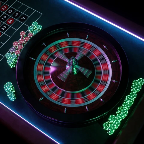 Live Roulette im Rainbet Live Casino - Neon-beleuchtetes Kesselrad von oben